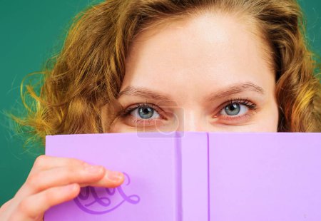 Photo for Closeup portrait of female teacher with notepad. School supplies. Education, learning. Back to school. Female college student hiding behind open book. Girl covering face with notebook. Knowledge day - Royalty Free Image