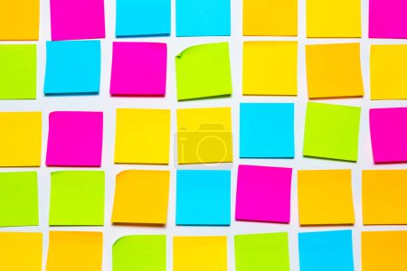 Photo for Colorful blank sticky notes on white wall isolated background. Reminder and business office supplies stationery wallpaper - Royalty Free Image