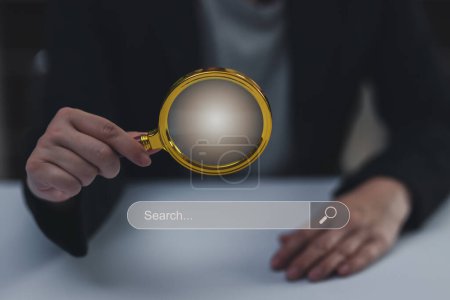 Photo for Concept of searching data networking and internet, Businesswoman wearing a suit holding a magnifying glass using computer tablet searching data or browsing online data internet data for information - Royalty Free Image