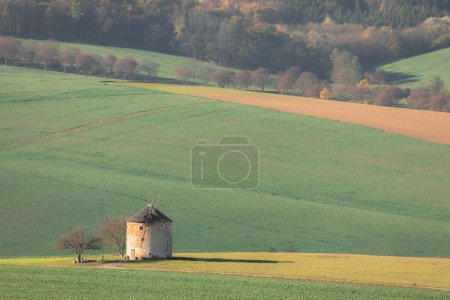 Photo for An old fashioned windmill in the agricultural, rural countryside landscape farmland of the Hodonin District in South Moravia, Czech Republic. - Royalty Free Image