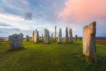 Photo for The historic site of Callanish Standing Stones, a Neolithic stone circle on the Isle of Lewis in the Outer Hebrides of Scotland at sunset or sunrise. - Royalty Free Image