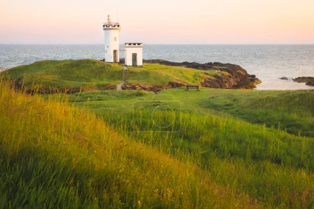 Photo for Scenic seascape landscape at sunset or sunrise of Elie Ness Lighthouse on the East Neuk Peninsula in coastal Fife, Scotland, UK. - Royalty Free Image