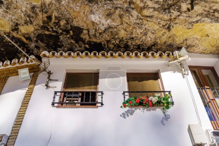 Photo for Houses dug into the rock of the mountain in the picturesque village of Setenil de las Bodegas, Cadiz, Spain - Royalty Free Image