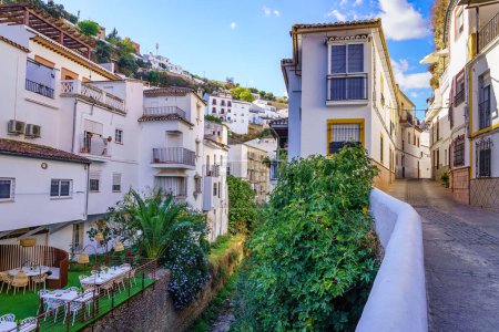 Photo for Setenil de las Bodegas, rustic village with cave houses on a sunny day with blue sky, in the province of Cadiz, Andalusia, Spain - Royalty Free Image