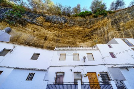 Photo for Houses dug into the rock of the mountain in the picturesque village of Setenil de las Bodegas, Cadiz, Spain - Royalty Free Image