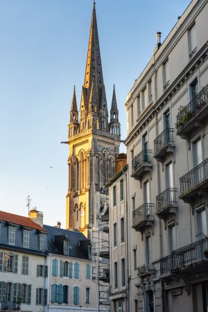 Photo for Tower of the church of San Martin standing out among the old buildings of the city, Pau France - Royalty Free Image