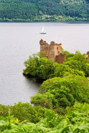 Photo for Medieval Urquhart Castle on the shore of Loch Ness on a hill overlooking the beautiful landscape, Scotland, UK - Royalty Free Image