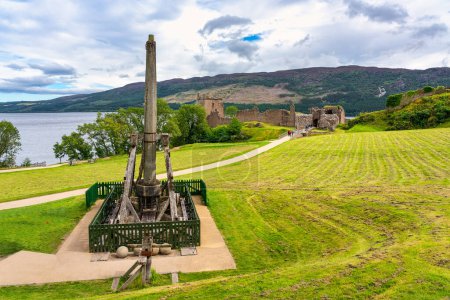 Photo for Urquhart Castle on Loch Ness with machines used in the Middle Ages to throw stones to the enemy, Scotland - Royalty Free Image