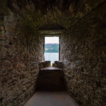 Photo for Small window overlooking Loch Ness from Urquhart Castle, construction of the Middle Ages, Scotland - Royalty Free Image