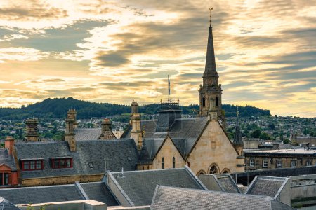 Photo for Cityscape of Inverness city at sunset with its medieval buildings and tall towers, Scotland - Royalty Free Image