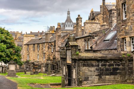 Very old graves located next to dwellings in Greyfriars Cemetery in Edinburgh, Scotland
