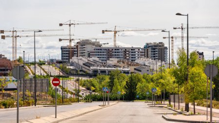 Photo for Multiple construction cranes to build homes in new areas of expansion, Madrid, Spain - Royalty Free Image