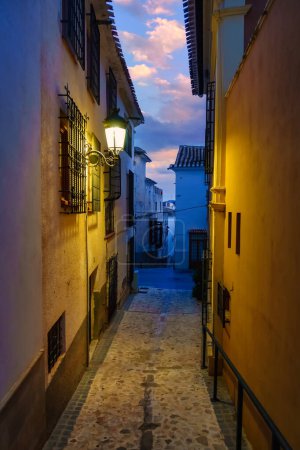Photo for Quaint narrow alley at dusk in the Andalusian village of Velez Rubio, Almeria, Spain - Royalty Free Image