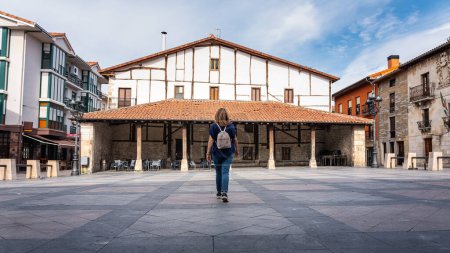Tourist woman visiting the main square of the picturesque village of Salvatierra, Basque Country, Spain