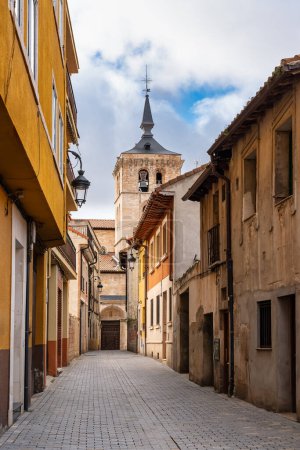 Picturesque alley with the church tower jutting out from the rooftops, Aranda de Duero
