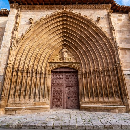 Medieval church facade highly decorated with stone carvings in Aranda de Duero, Burgos.