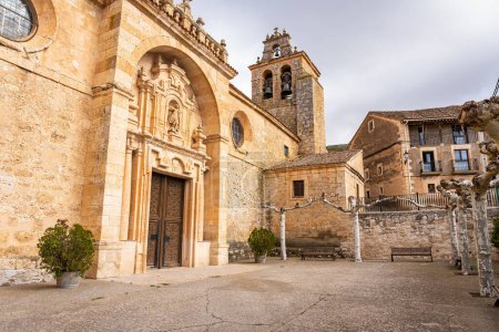 Medieval church facade with tower and bell tower in the old villages of Castilla Leon
