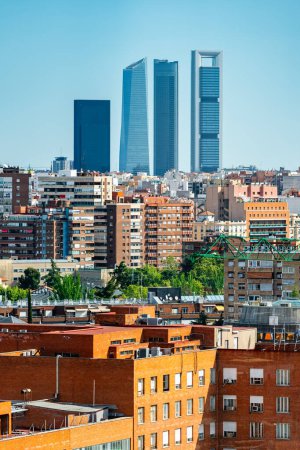 Skyscrapers of Madrids financial district emerge among the buildings of the city, Spain