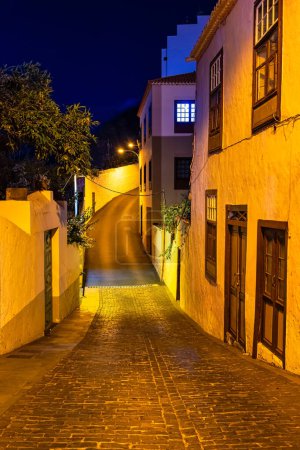 Narrow cobbled and very steep street illuminated with street lamps at night, Santa Cruz, La Palma