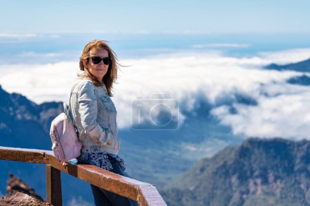 Tourist woman enjoying the stunning views from the top of the mountain, La Palma island, Canary Islands