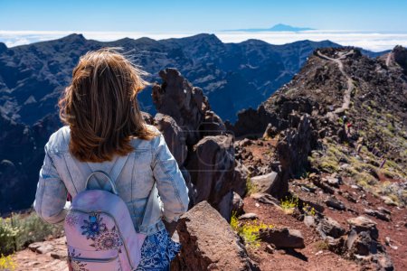 Woman with her back turned contemplating the breathtaking views of the Canarian landscape, La Palma