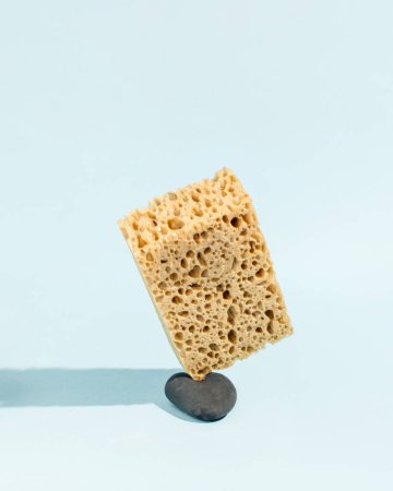 Photo for A stone destroyed by the weight of the sponge, minimal creative concept, absurd idea. - Royalty Free Image