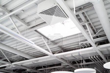 Ventilation System Under Ceiling of Modern Warehouse or Shopping Center. Metal Piping for Air Conditioning