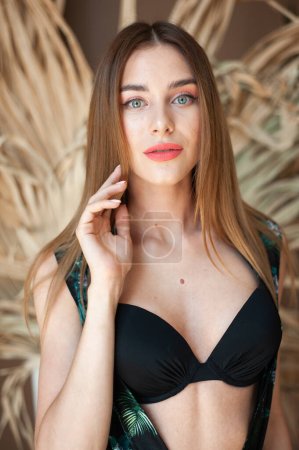 Photo for Lifestyle sunny portrait of young beauty woman posing in sunny interior stylish beachwear pareo - Royalty Free Image