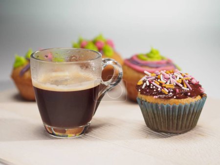 Photo for Muffins with colorful decoration and coffee on white table - Royalty Free Image