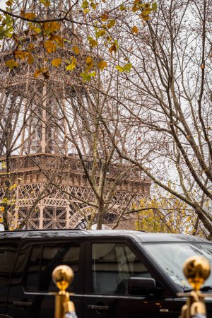 Photo for Secret service atmosphere at the foot of the Eiffel Tower in Paris in autumn - France - Royalty Free Image
