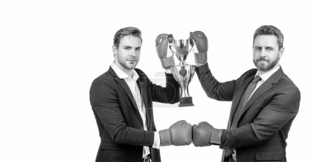 Photo for Celebrating success. trophy and prestige. got prize. winning deal. businessmen in boxing gloves celebrate victory. entrepreneur team of year. partners hold golden cup. business achievement award - Royalty Free Image