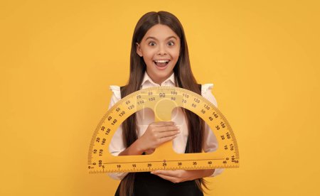 Photo for Amazed teen girl in school uniform hold mathematics protractor for measuring, education. - Royalty Free Image