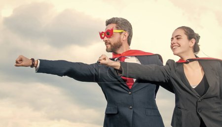 business people in superhero suit on sky background.