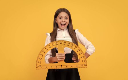 Photo for Mathematics. surprised teen girl hold protractor ruler. back to school. algebra and geometry. kid study math. measure the size. trigonometry stationery. measuring and sizing. education for child. - Royalty Free Image