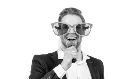 Photo for Portrait of happy man in formalwear and funny glasses sing song to microphone isolated on white, singing. - Royalty Free Image