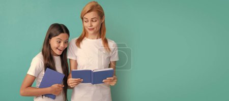 Foto de Mother and daughter child banner, copy space, isolated background. private teacher and curious kid reading book, september - Imagen libre de derechos