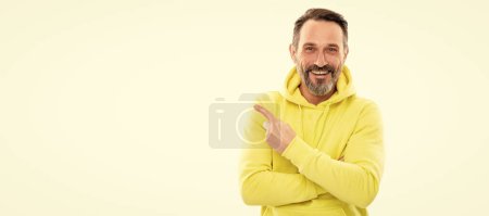 look here. adult guy advertising. male casual sporty fashion. copy space. happy man pointing finger. Man face portrait, banner with copy space