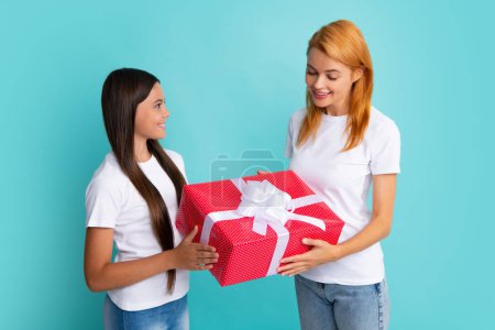 Love mom. Smiling mother and daughter with gift box. Cheerful mom and her cute daughter girl with gifts