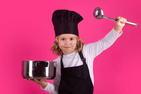 Photo for Child chef cook with cooking pot and ladle. Excited chef cook. Child wearing cooker uniform and chef hat preparing food, studio portrait - Royalty Free Image