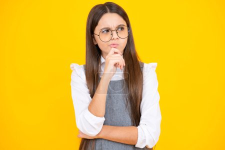 Photo for Thinking teenager girl, thoughtful emotion. Smart nerdy school girl touching cheek and thinking against yellow background. Child think and idea concept - Royalty Free Image