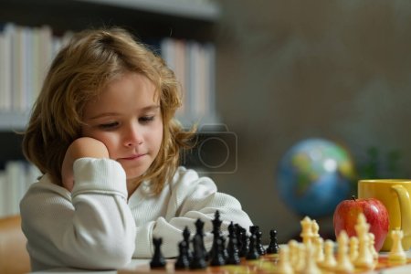 Foto de Chess school. Child think or plan about chess game in classroom. Intelligent, smart and clever school kids. Brain development and logic - Imagen libre de derechos