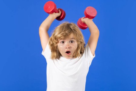 Photo for Kids sports exercises. Healthy kids life and sport concept. Portrait of child boy working out with dumbbells. Motivation and sport concept for children - Royalty Free Image