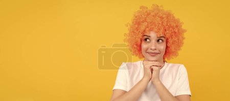 dreamy freaky woman in curly clown wig for party, dreaming. Woman isolated face portrait, banner with copy space