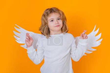 Photo for Child angel crossed fingers with lucky and hope, good luck. Valentines day. Little cupid angel child with wings. Studio portrait of angelic kid - Royalty Free Image