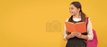Photo for Learning for life. Happy children read books yellow background. Portrait of schoolgirl student, studio banner header. School child face, copyspace - Royalty Free Image