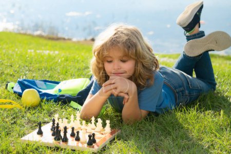 Foto de Chess game for children. Kid playing chess. Games and activities for children - Imagen libre de derechos