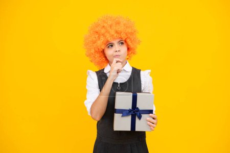 Photo for Child teen girl 12-14 years old with gift on isolated background. Birthday, holiday concept. Teenager hold present box. Thinking face, thoughtful emotions of teenager girl - Royalty Free Image