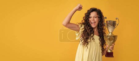 Photo for Happy teen girl hold golden cup. achievement award. celebrating success and victory. Horizontal poster of isolated child face, banner header, copy space - Royalty Free Image