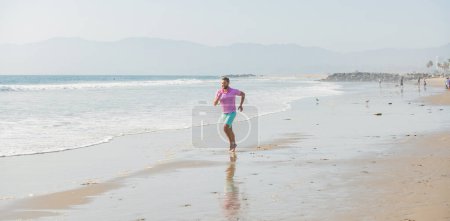 Foto de Sport athletic man running on summer beach for training, freedom. - Imagen libre de derechos
