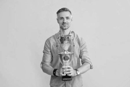 Photo for Motivation of business success. trophy and prestige. got prize. guy celebrate victory. inspiration and motivation. smiling mature man hold golden cup. achievement award. - Royalty Free Image